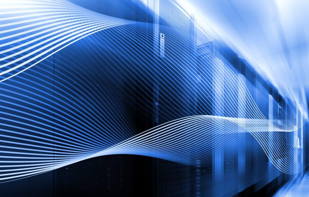 Abstract digital image with blue tones shows a server room with rows of servers and white, wavy lines overlaying the scene, symbolizing data flow, technology, and network connectivity.