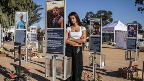 A woman stands at the memorial to the victims of the 2023 Hamas attacks at the Nova festival site in Reim, southern Israel, on October 7, 2026. Israel marked the third anniversary of Hamas's October 7 attack with silent tributes, new strikes on Gaza and intense political debate, weeks before elections in which the country's deadliest day will be front and centre. (P