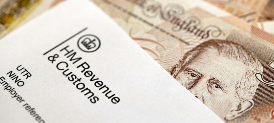HM Revenue and Customs document placed over British pound banknotes